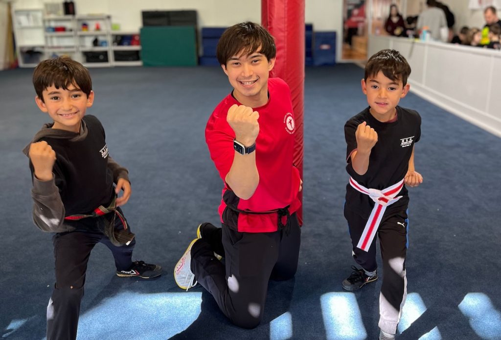 an instructor with two children showing confidence and joy