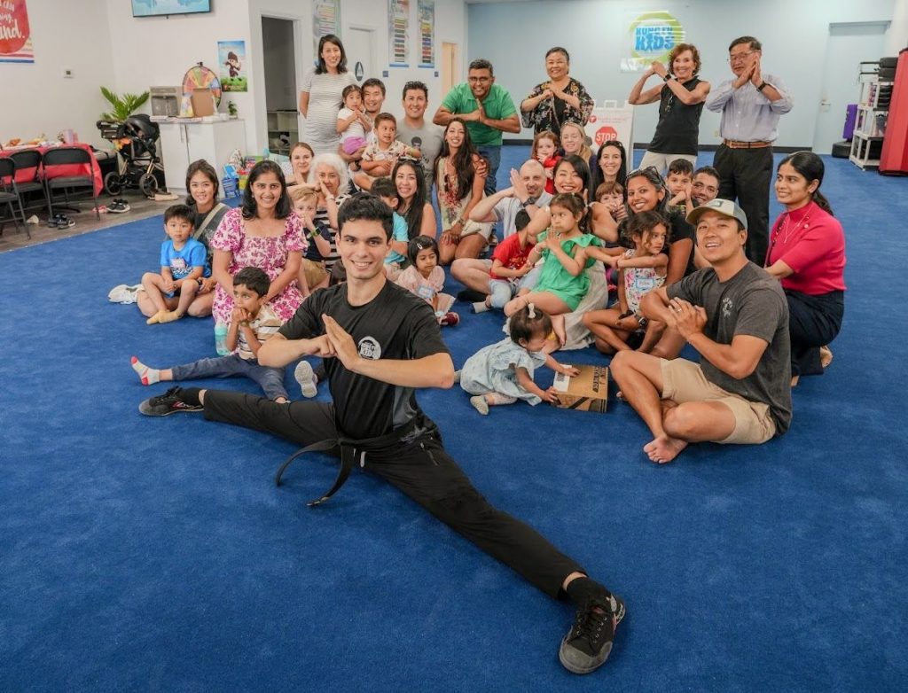 a group of happy parents and their children at Kung Fu Kids